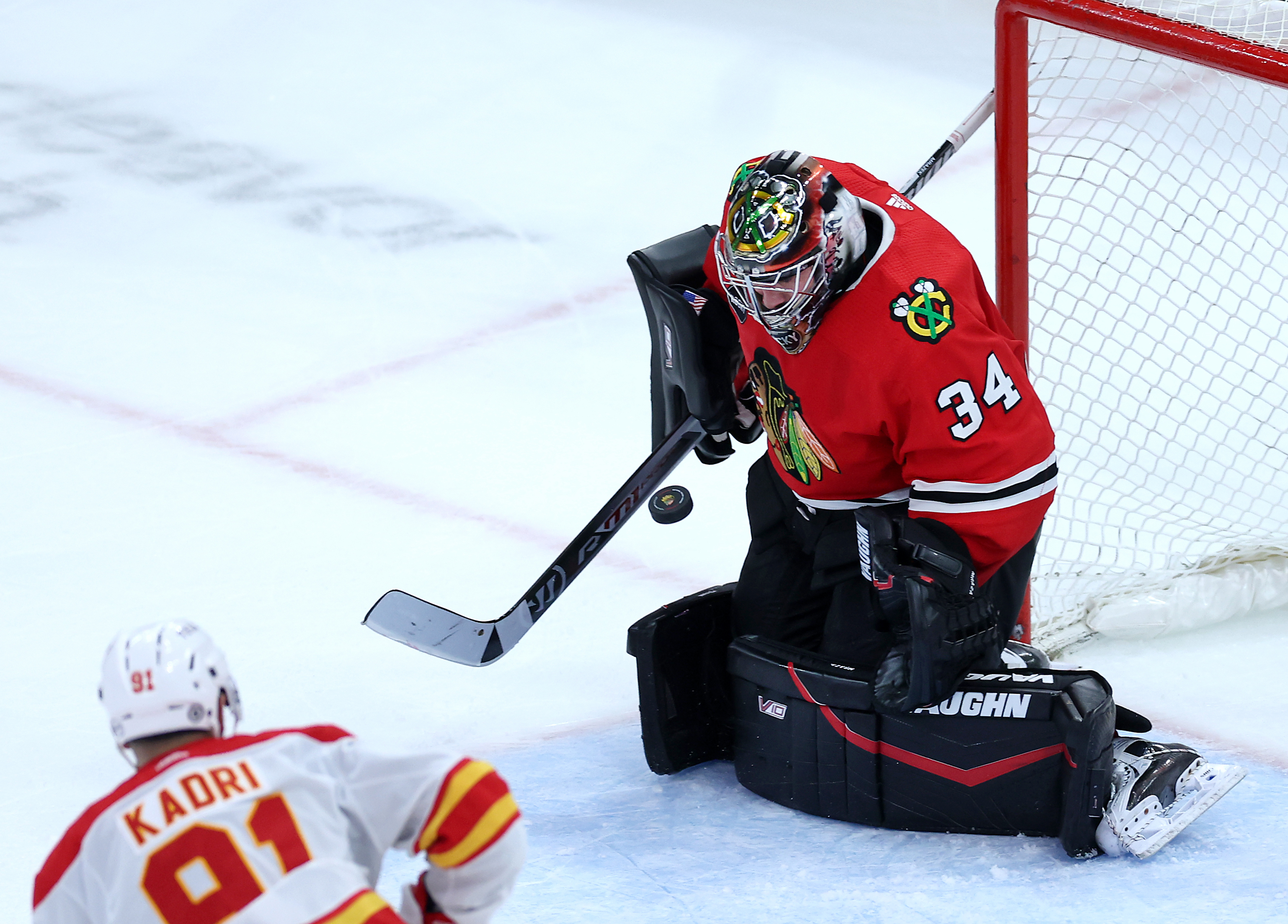 Chicago Blackhawks goaltender Petr Mrazek (34) blocks a shot in the third period of a game against the Calgary Flames at the United Center in Chicago on March 26, 2024. (Chris Sweda/Chicago Tribune)