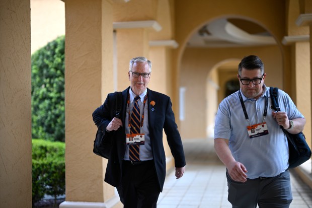 Chicago Bears Chairman George H. McCaskey, left, walks to an interview with the Bears Vice President of Communications Brandon Faber at the NFL owners meetings, Tuesday, March 26, 2024, in Orlando, Fla. (AP Photo/Phelan M. Ebenhack)