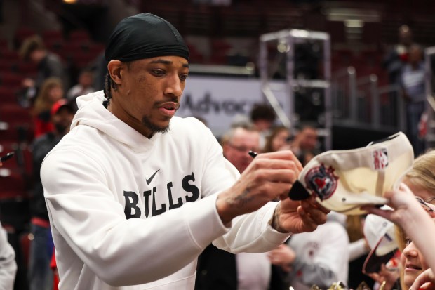 Chicago Bulls forward DeMar DeRozan signs items for fans before the game against the Detroit Pistons at the United Center on Sunday, April 9, 2023. (Eileen T. Meslar/Chicago Tribune)