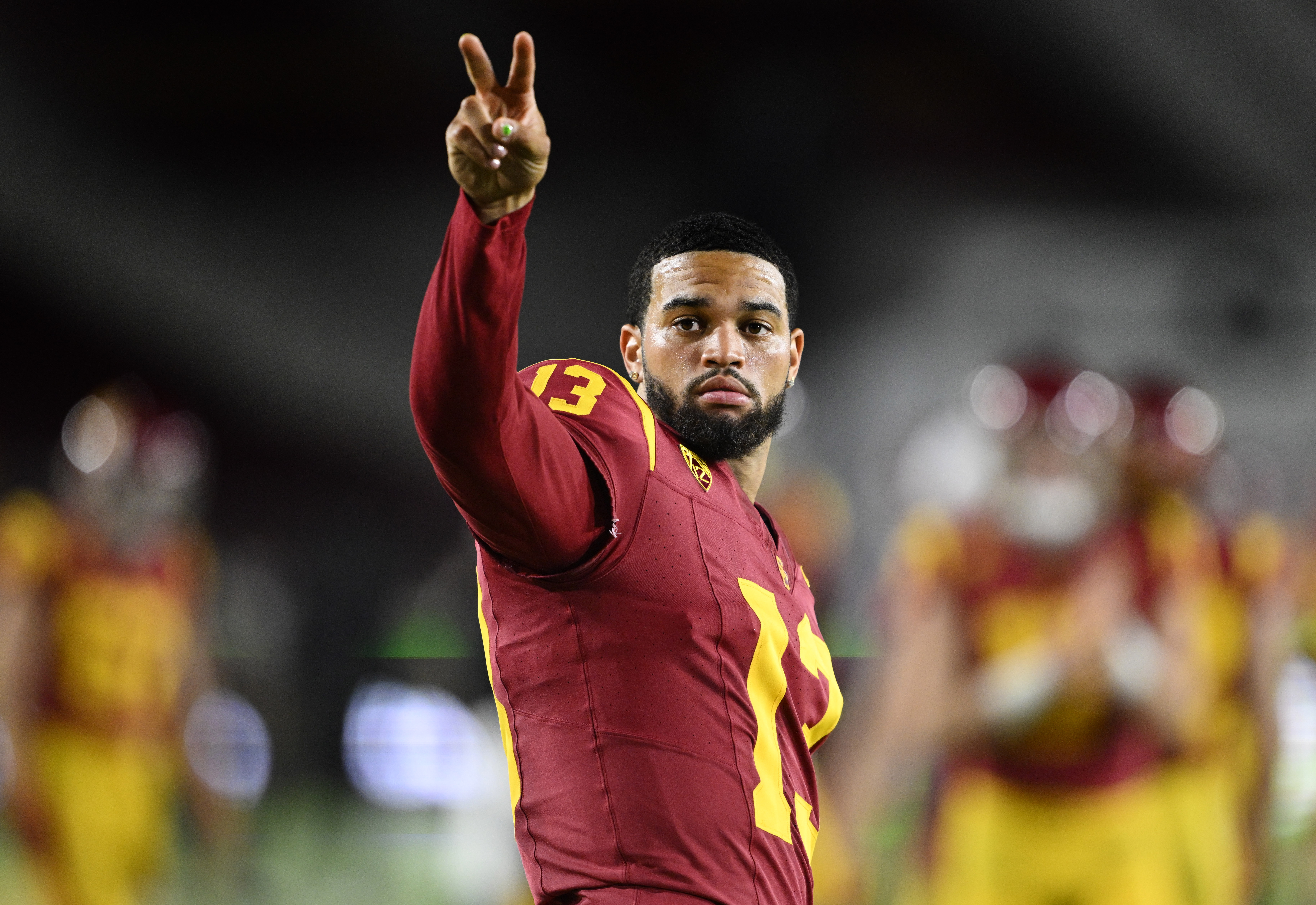 Quarterback Caleb Williams gives the victory sign to the crowd...