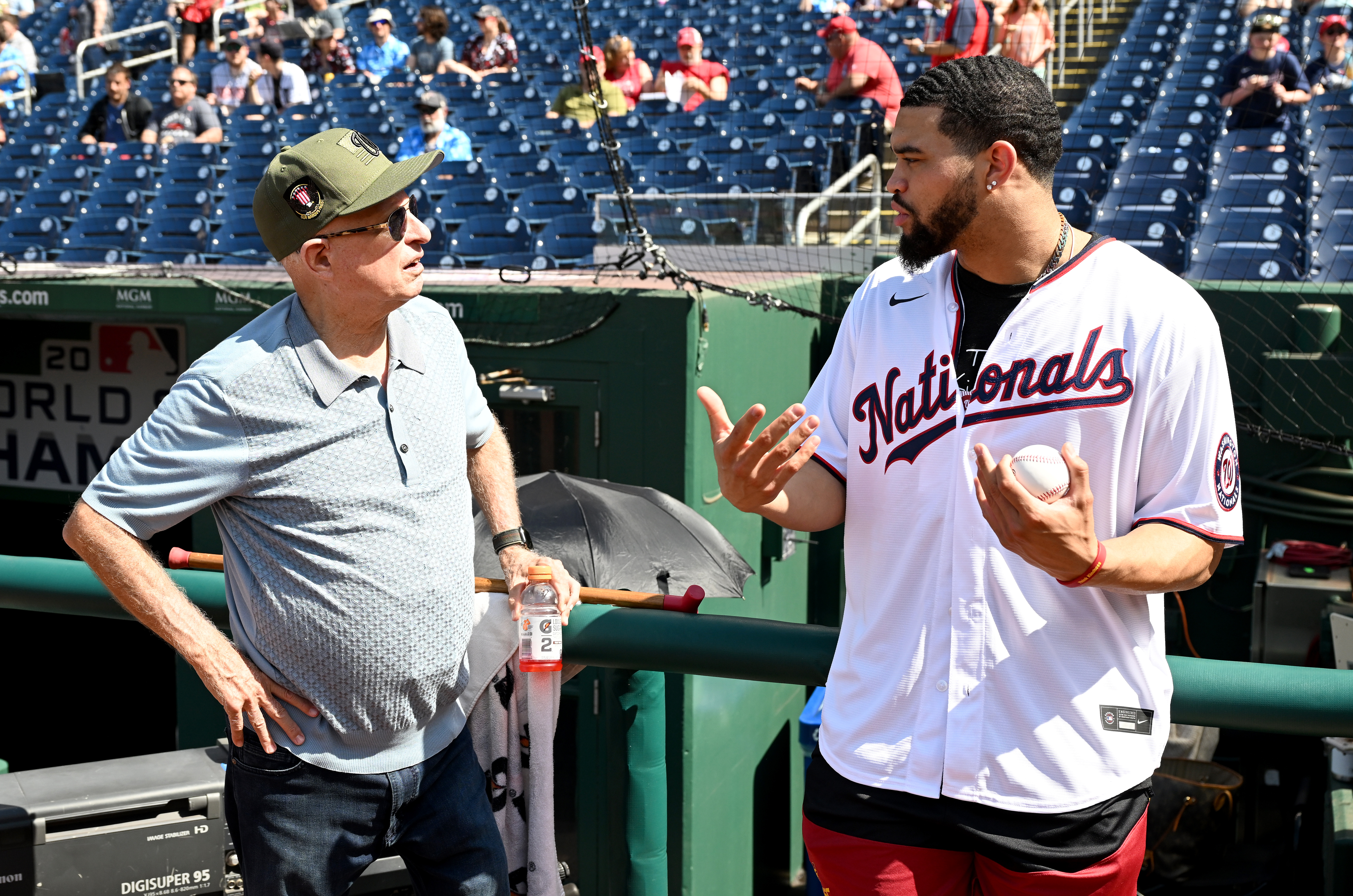 Nationals owner Mark Lerner talks with USC quarterback Caleb Williams...