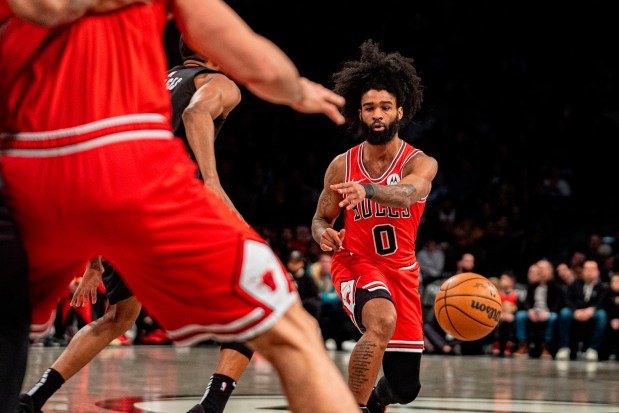 Bulls guard Coby White passes the ball to center Nikola Vučević during the first half against the Nets on March 29, 2024, in New York. (Peter K. Afriyie/AP)