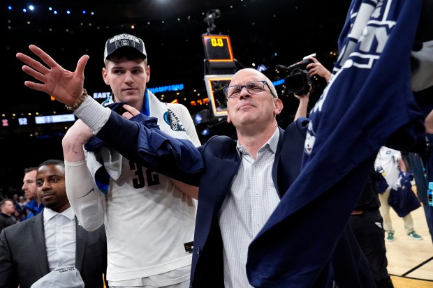 UConn coach Dan Hurley celebrates with center Donovan Clingan after defeating Illinois in the Elite Eight of the NCAA Tournament on March 30, 2024, in Boston. (Michael Dwyer/AP)