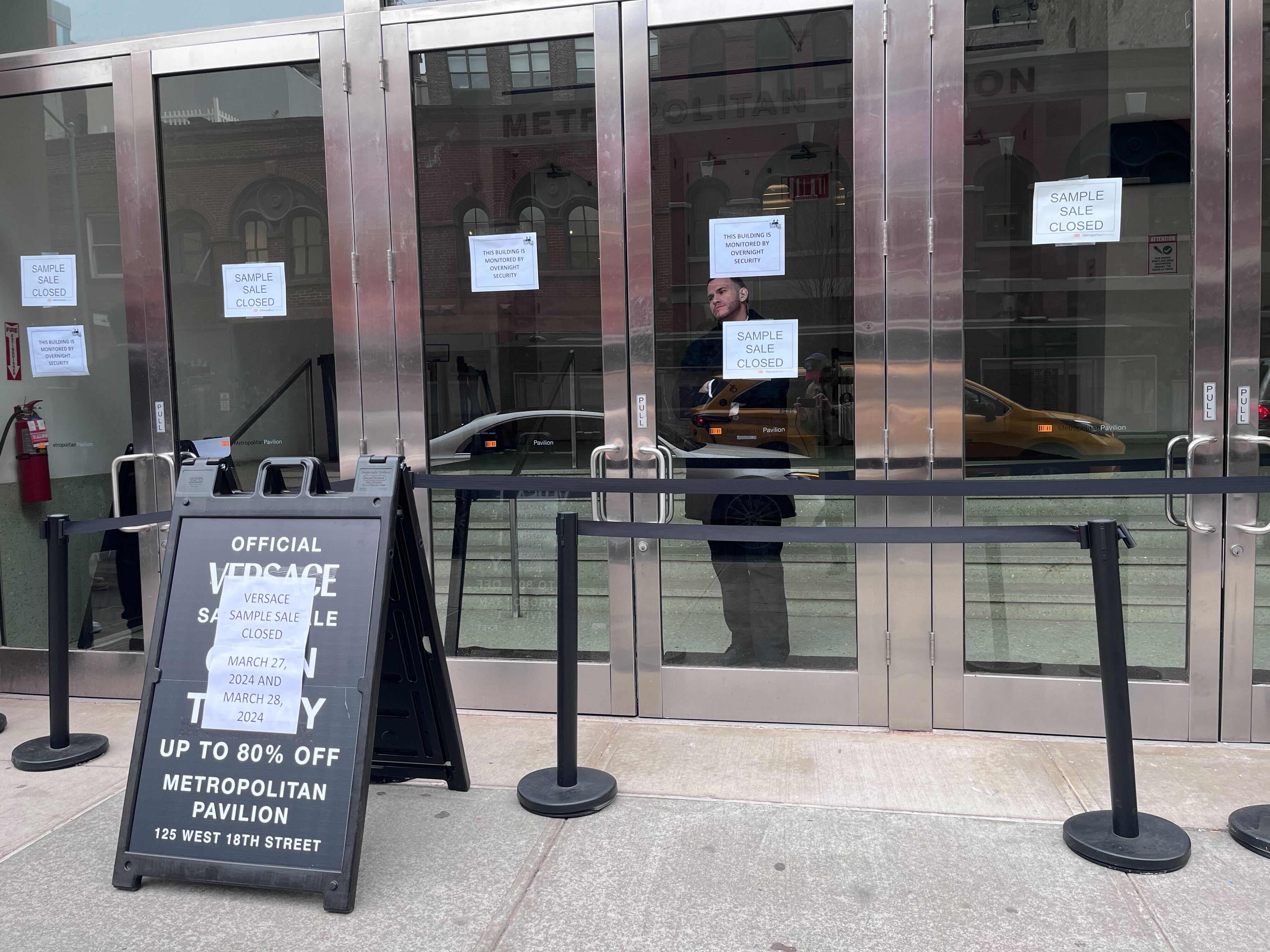 The exterior of a SoHo Versace store with a sign that says