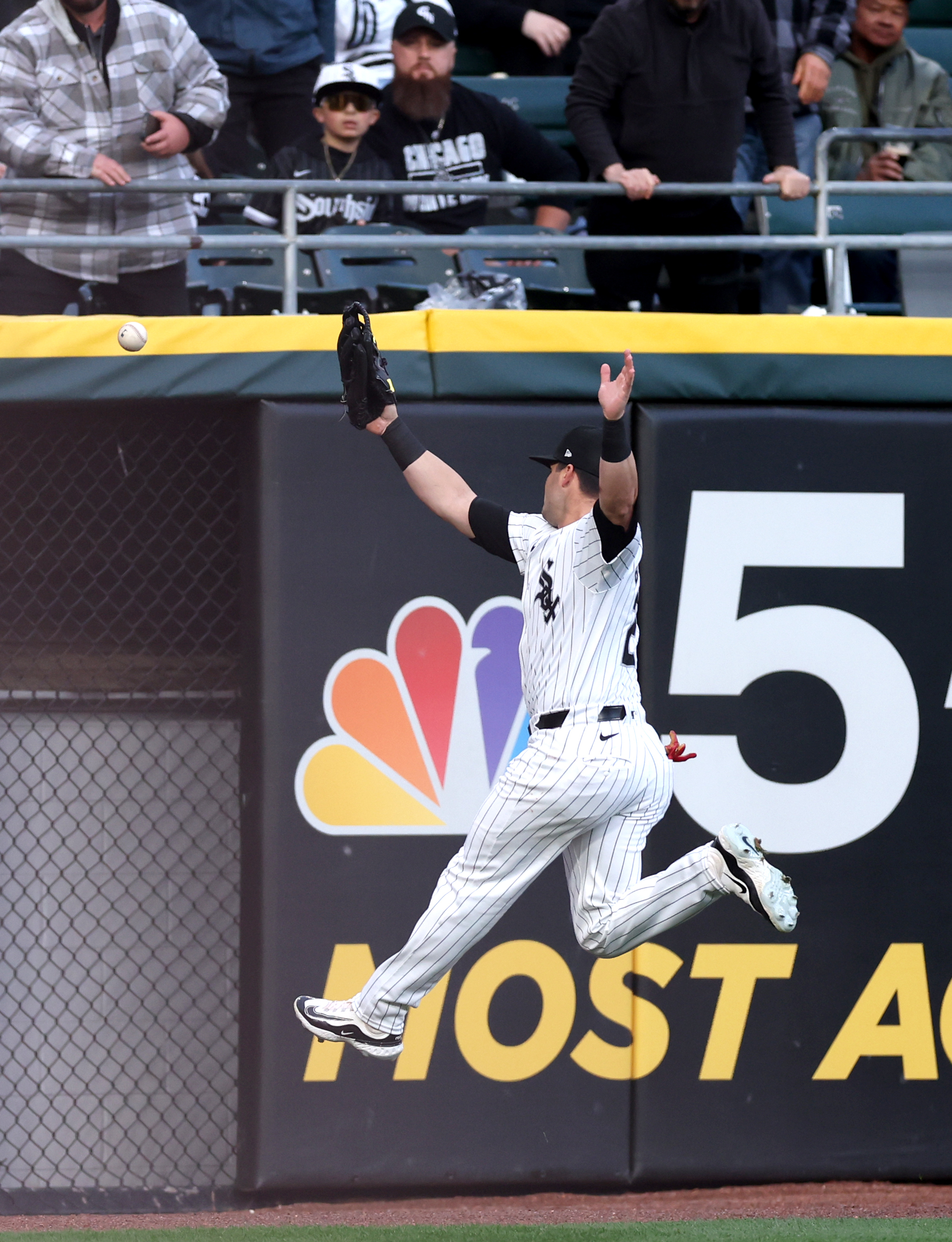 White Sox left fielder Andrew Benintendi is unable to catch a ball that went for a double for Reds outfielder Spencer Steer in the first inning on April 12, 2024, at Guaranteed Rate Field. (Chris Sweda/Chicago Tribune)