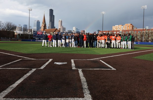 Jones College Prep and Morgan Park players, with guests from various baseball organizations, gather for a group picture during a Chicago Public League Jackie Robinson Baseball Weekend game at Granderson Stadium on the UIC campus on April 12, 2024. (John J. Kim/Chicago Tribune)