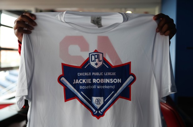 Andrew Atlas, 14, displays a T-shirt given to participants in the Chicago Public League Jackie Robinson Baseball Weekend before a game between Morgan Park and Jones College Prep at Granderson Stadium on the UIC campus on April 12, 2024. (John J. Kim/Chicago Tribune)