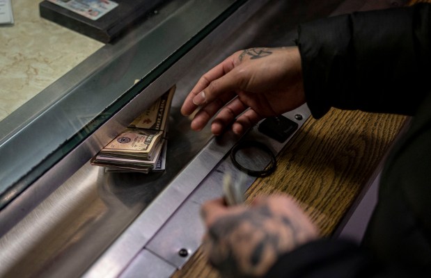 Before bail reform, a man pays cash bail in the bond office to secure his brother's release, Dec. 21, 2022, at Division 5 of Cook County Jail. (Brian Cassella/Chicago Tribune)