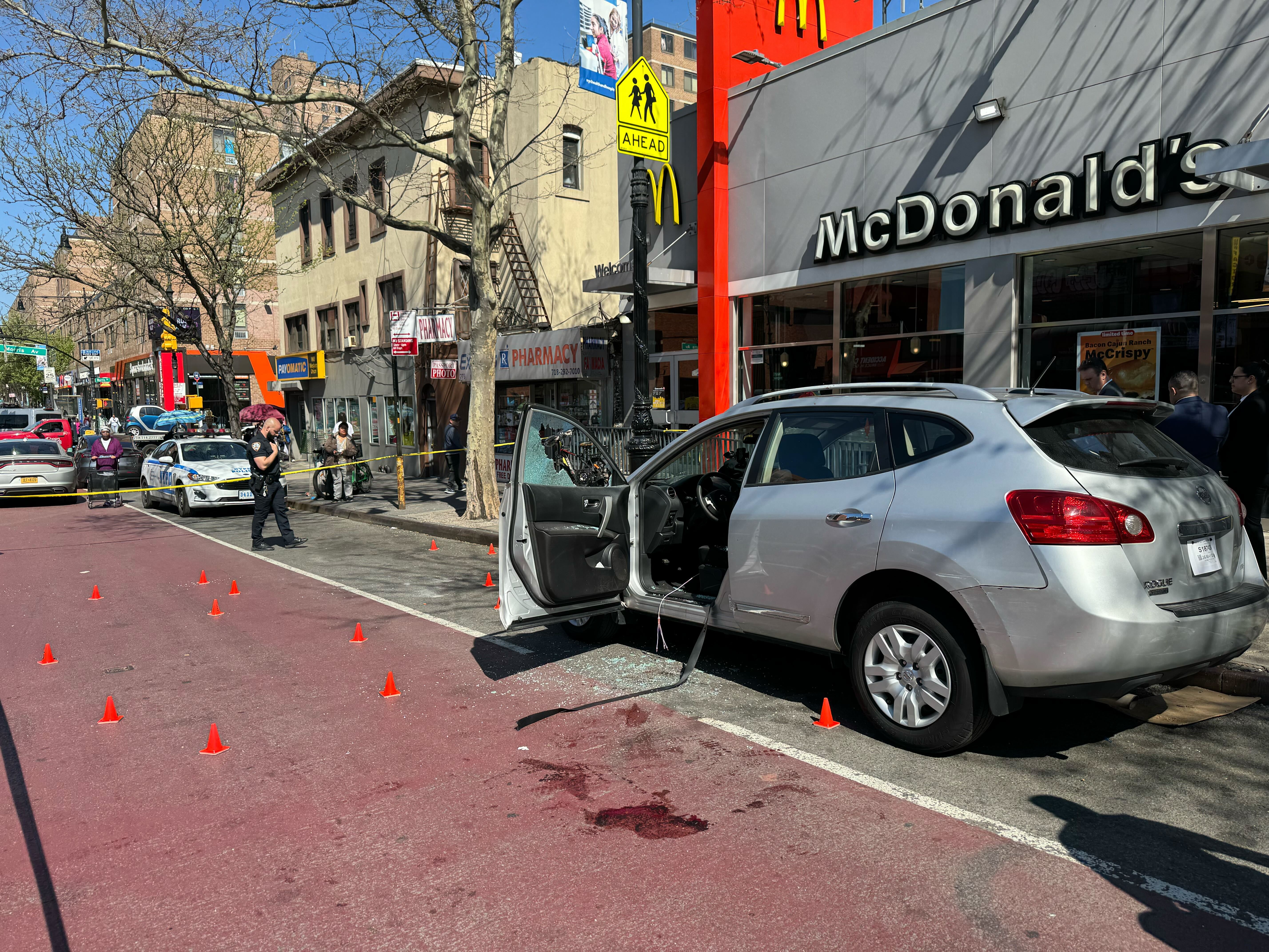 Police were examining a silver Nissan Rogue SUV at the scene of a shooting at 279 East 149 St. on April 15, 2024.