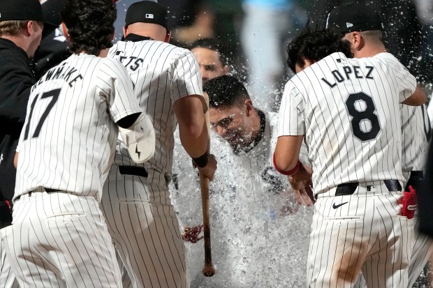 White Sox left fielder Andrew Benintendi, center, celebrates with teammates after his walk-off home run against the Rays on April 27, 2024, at Guaranteed Rate Field. The Sox won 8-7 in 10 innings. (Charles Rex Arbogast/AP)