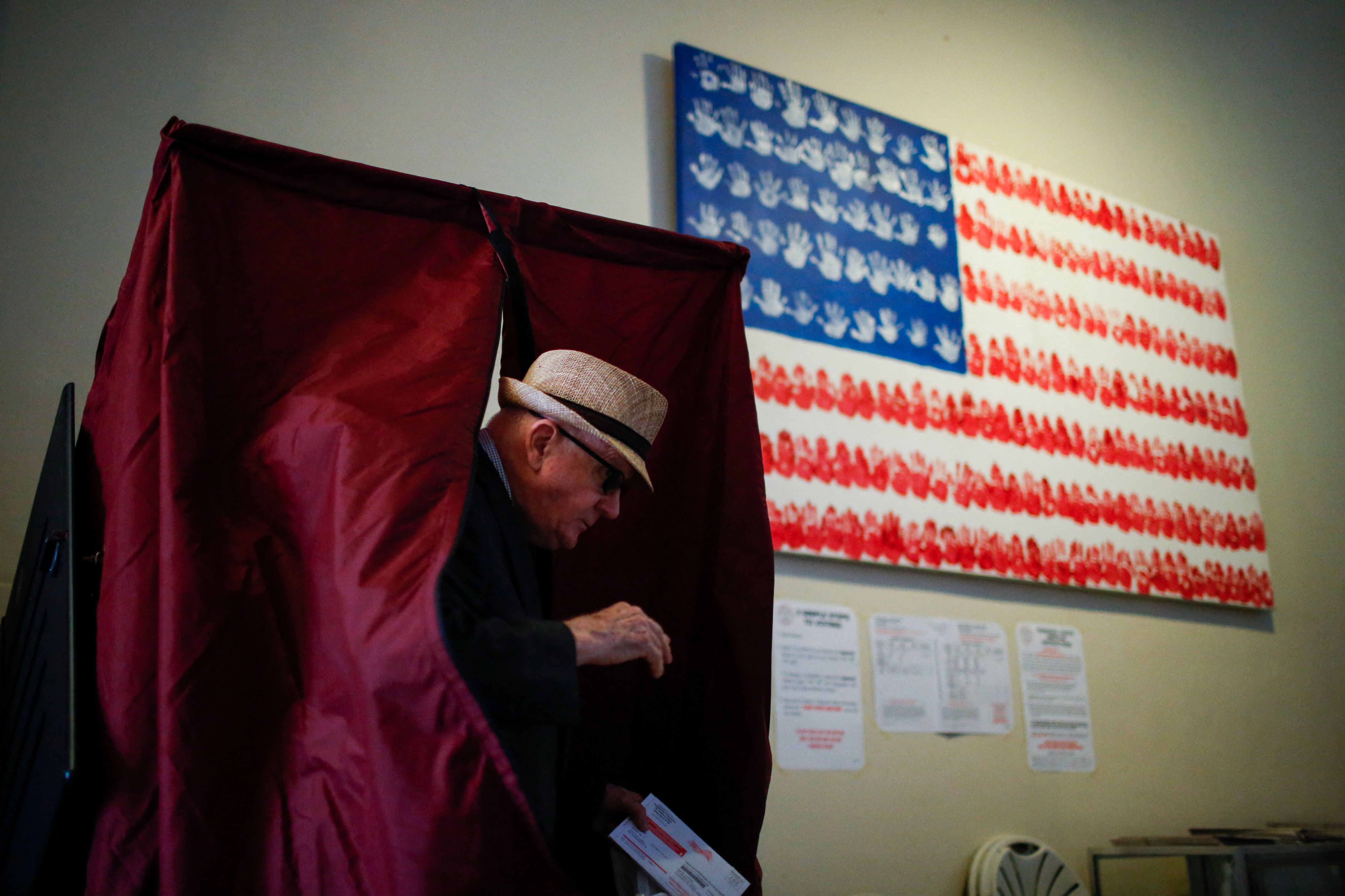 A man exits a polling booth.