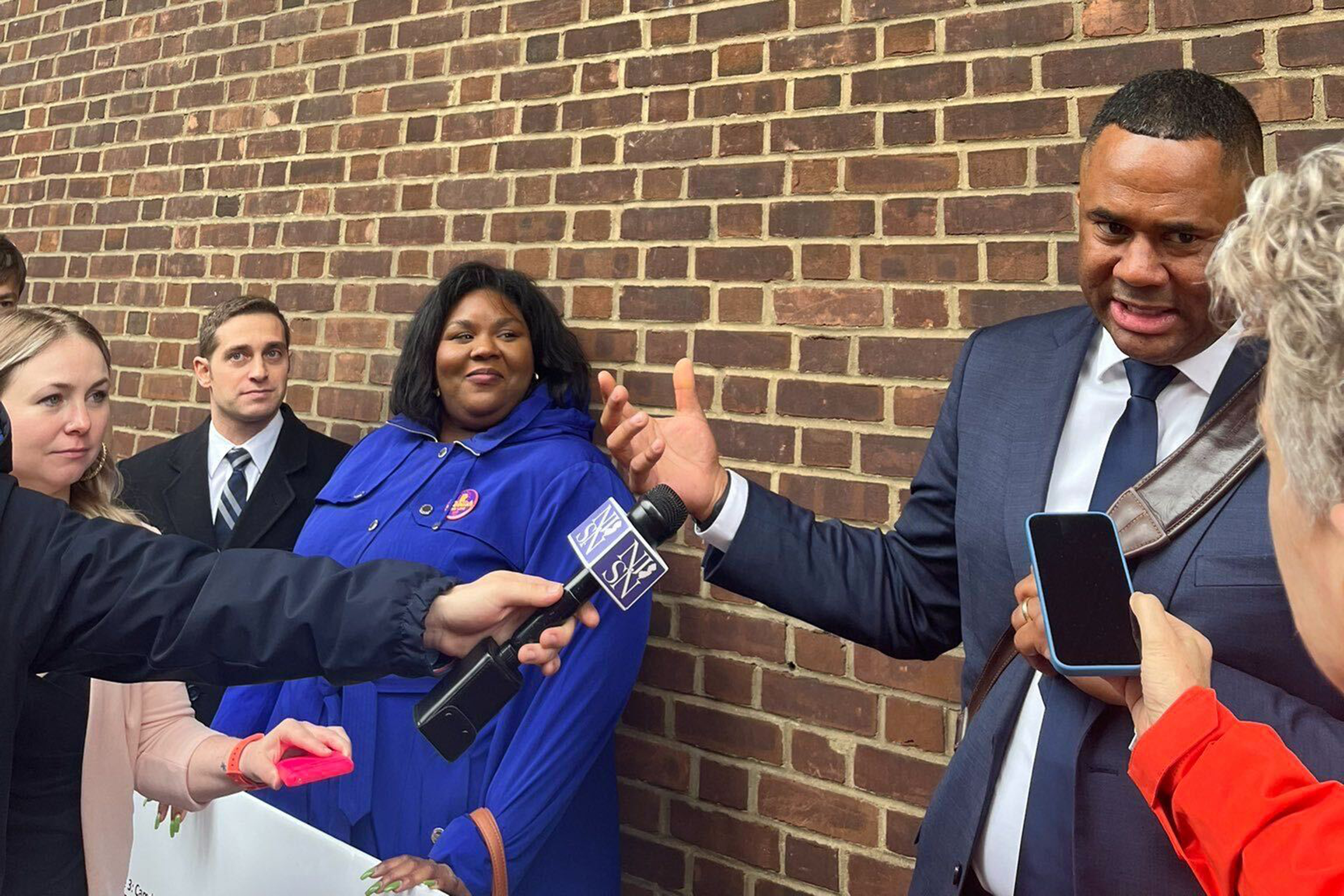 Attorney Ryan Haygood representing the New Jersey Institute for Social Justice, Antoinette Miles of the New Jersey Working Families Party, and attorney Brett Pugach representing Rep. Andy Kim speak outside a Third Circuit Court of Appeals hearing in Philadelphia Friday.