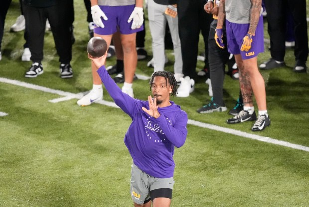 Quarterback Jayden Daniels runs through passing drills during LSU pro day in Baton Rouge, La., on March 27, 2024. (AP Photo/Gerald Herbert)