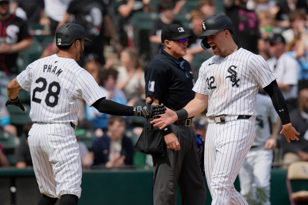 Chicago White Sox's Tommy Pham, left, celebrates with Gavin Sheets after they scored on a two-run single by Andrew Benintendi during the eighth inning of a baseball game against the Tampa Bay Rays in Chicago, Sunday, April 28, 2024. (AP Photo/Nam Y. Huh)