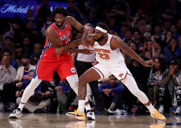 oel Embiid and Mitchell Robinson fight for position in Game 1 of the Eastern Conference first-round playoff game on Saturday. (Photo by Elsa/Getty Images)