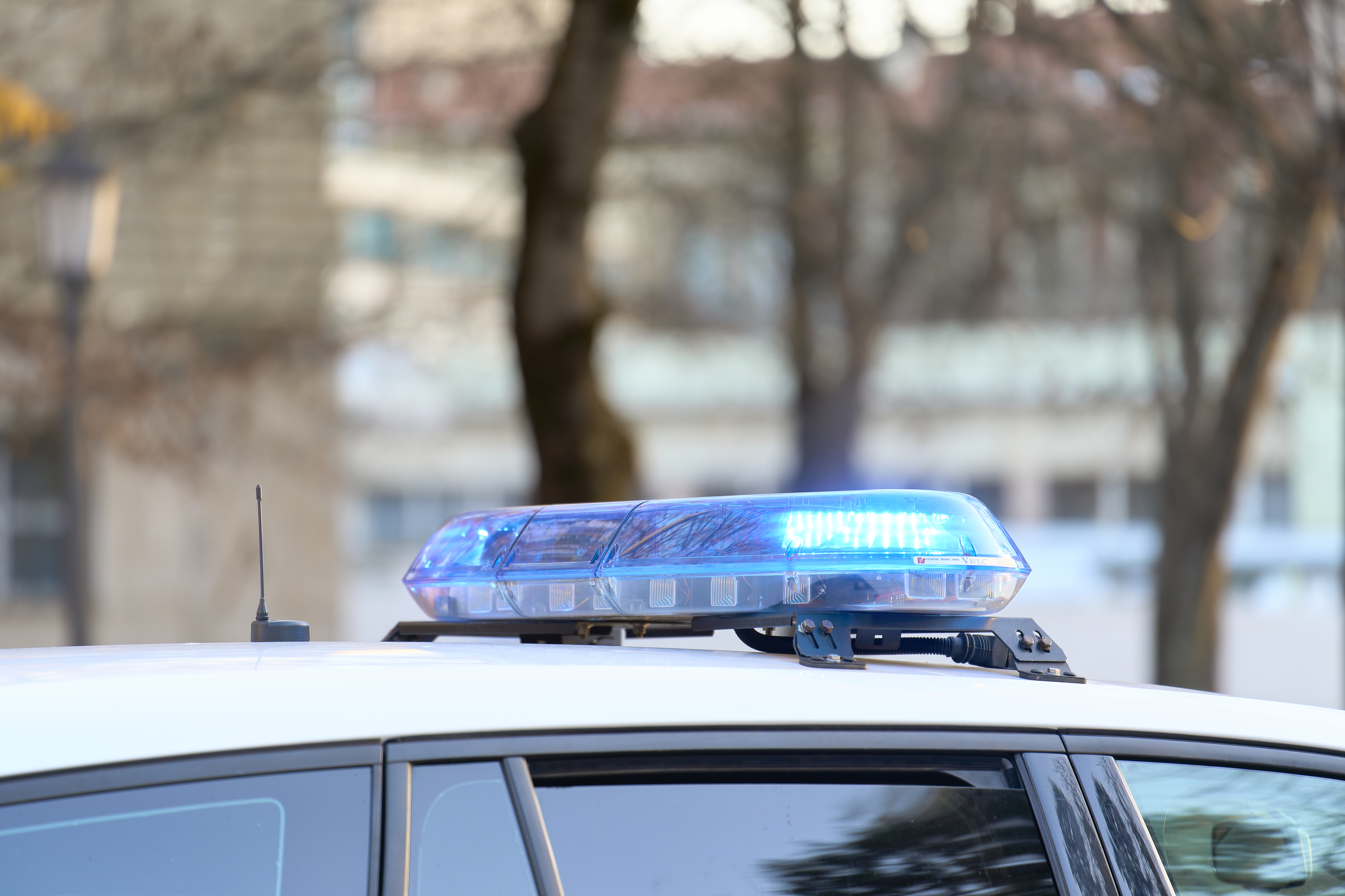 A close-up view of a police vehicle with blue lights.