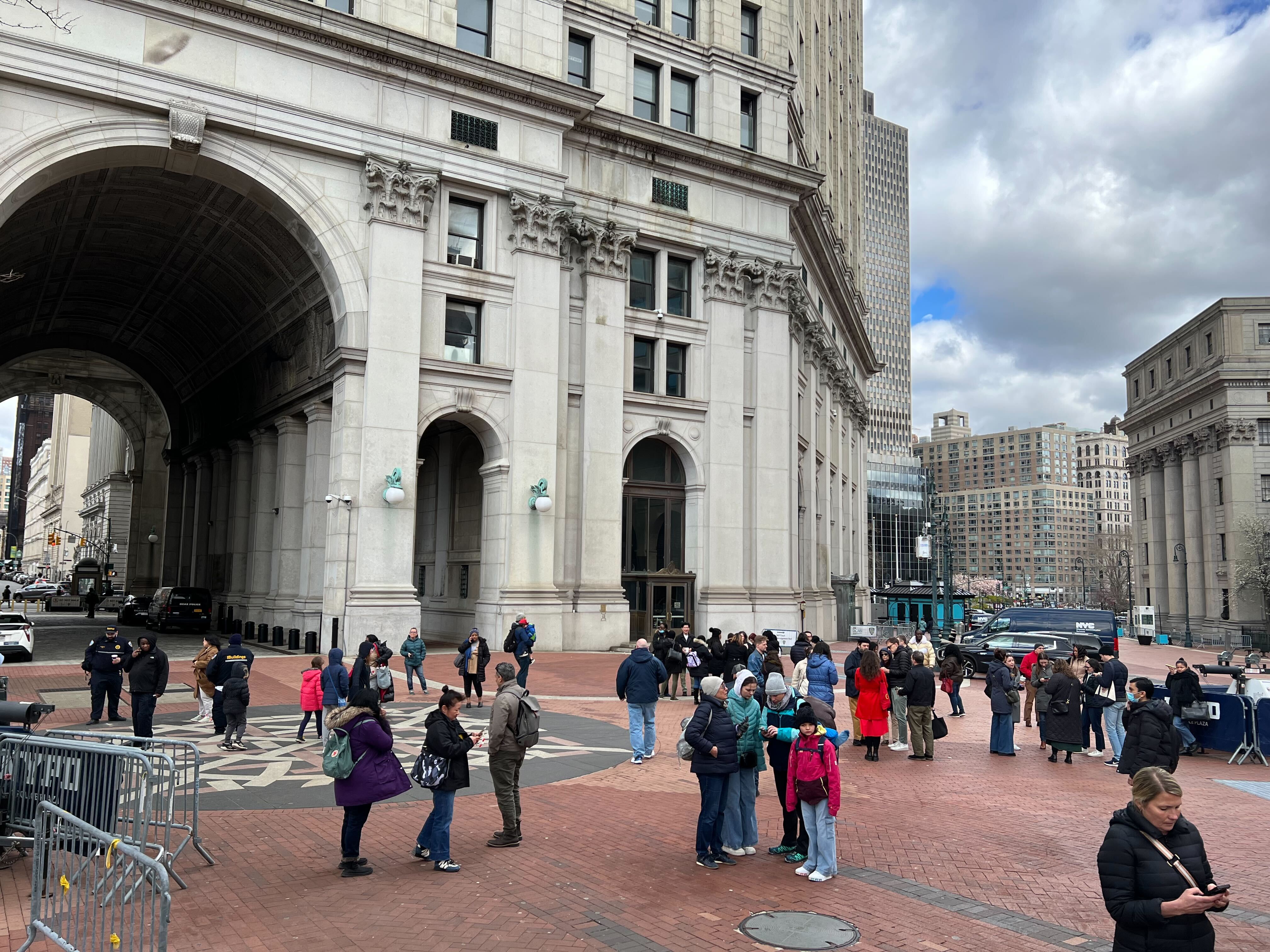 People gather outside a municipal building at 1 Centre Street shortly after the earthquake Friday morning.