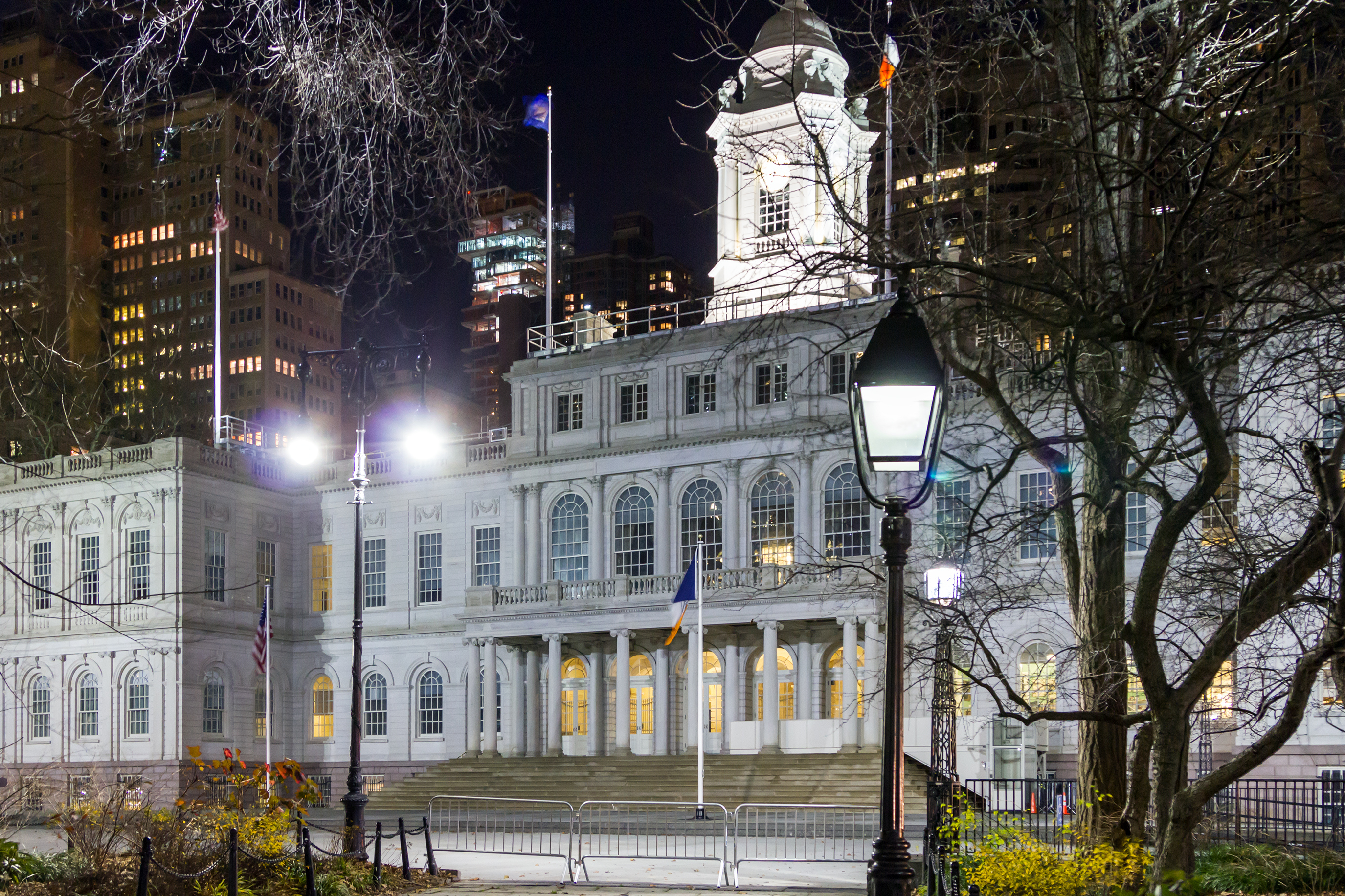 City Hall building with lights at night in Lower Manhattan.