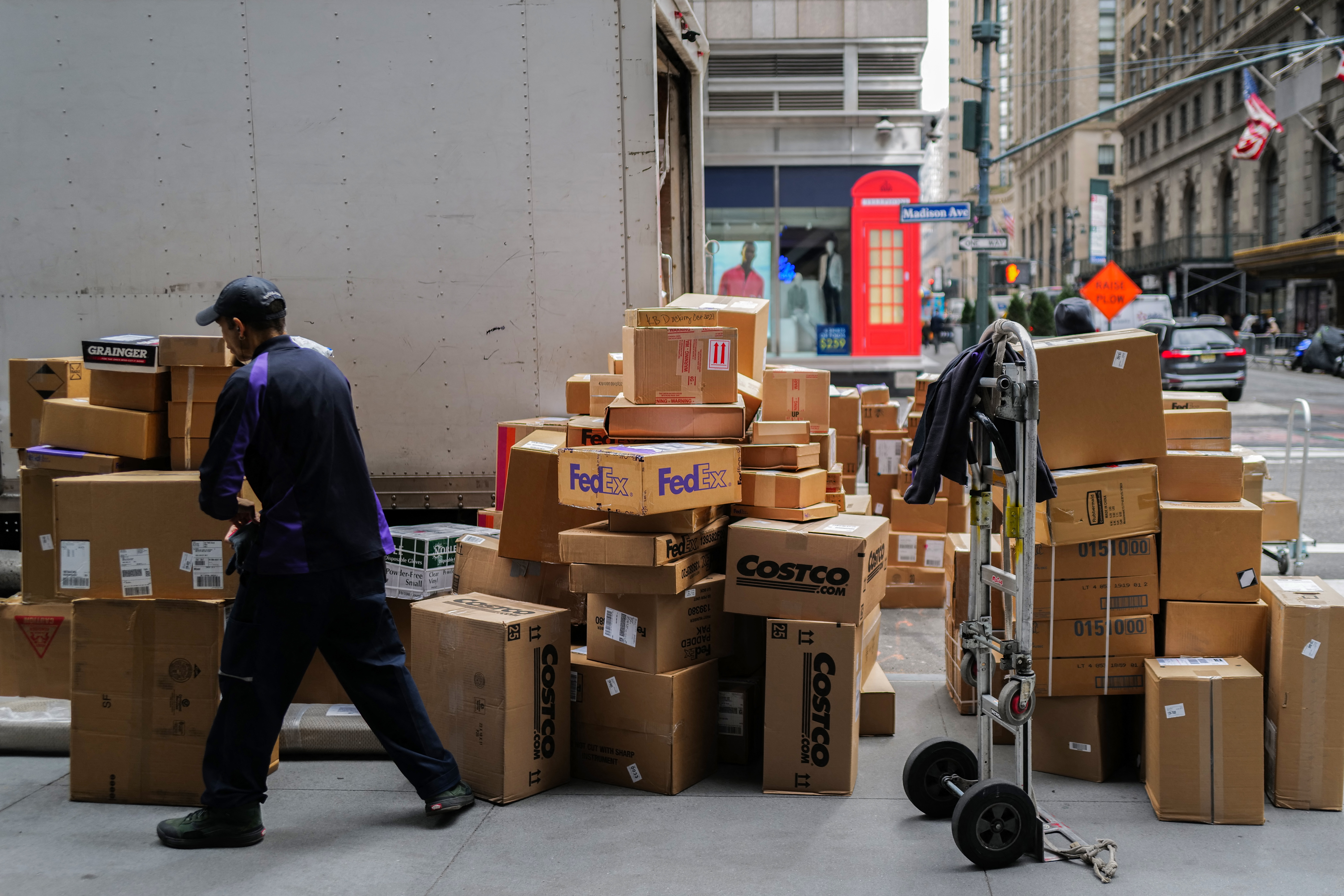 A FedEx employee sorts out parcels in a street in Manhattan.