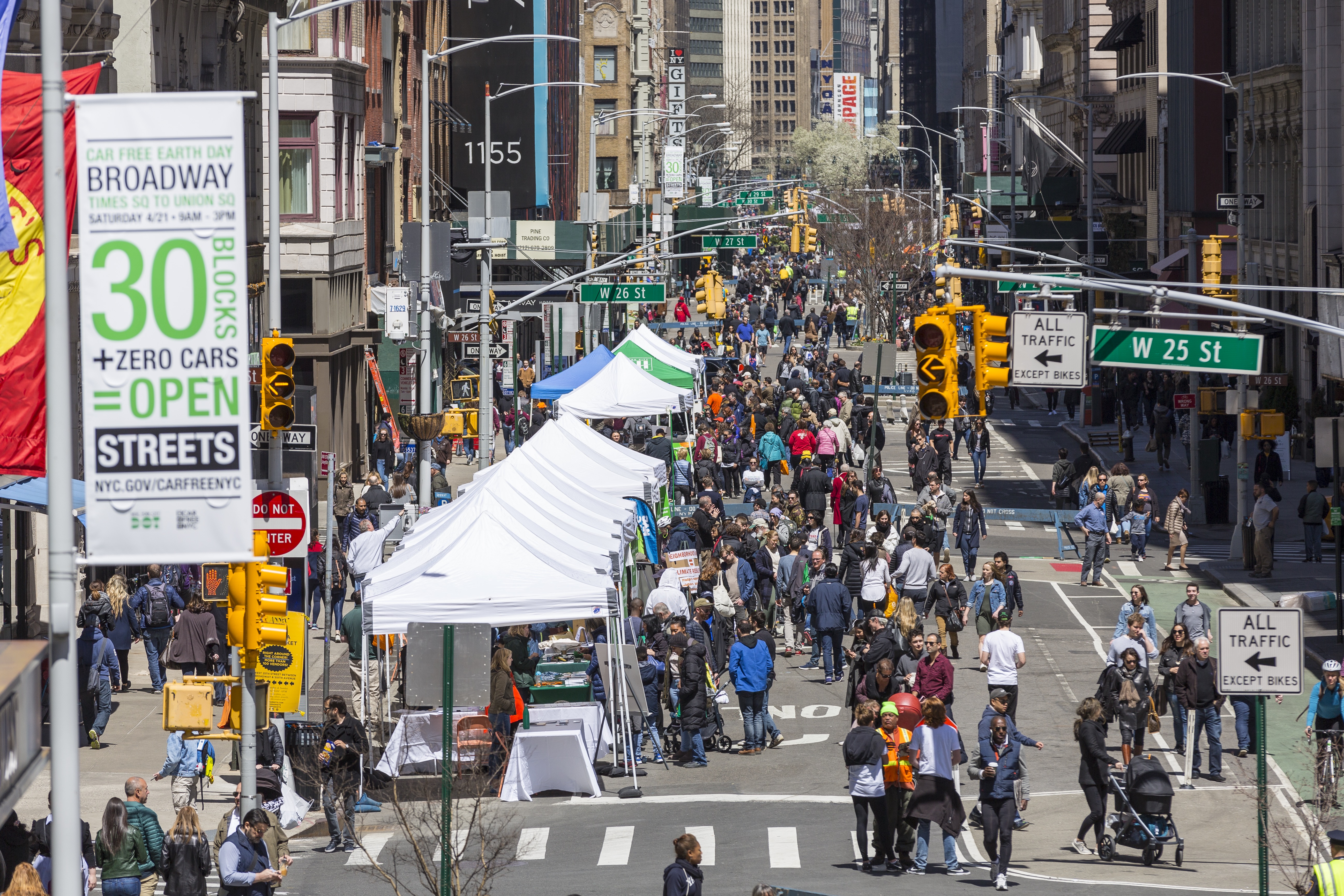 A crowd of pedestrians enjoying car free Earth Day.