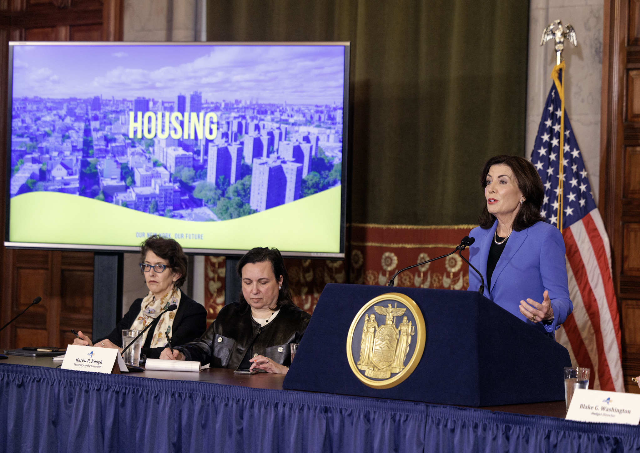 Gov. Kathy Hochul and members of her cabinet show a presentation on housing.