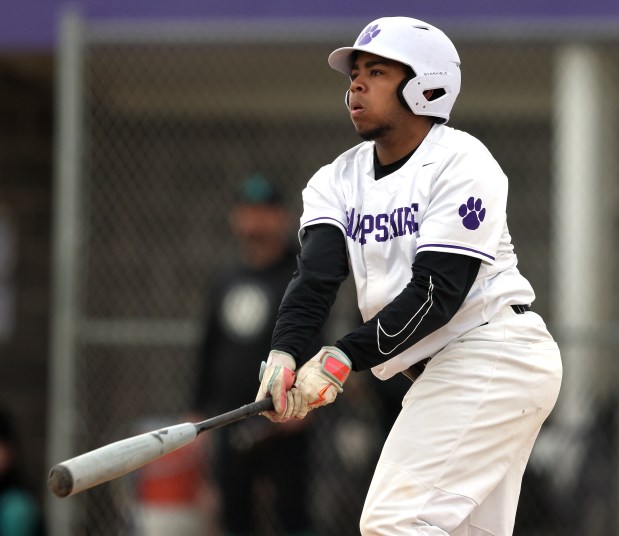 Hampshire's Wilson Wemhoff (21) watches his hit sail into center field for a double in the first inning against Woodstock North during a non-conference game on Thursday, April, 11, 2024 in Hampshire. Hampshire won, 15-0 in four innings.H. Rick Bamman / For the Beacon News