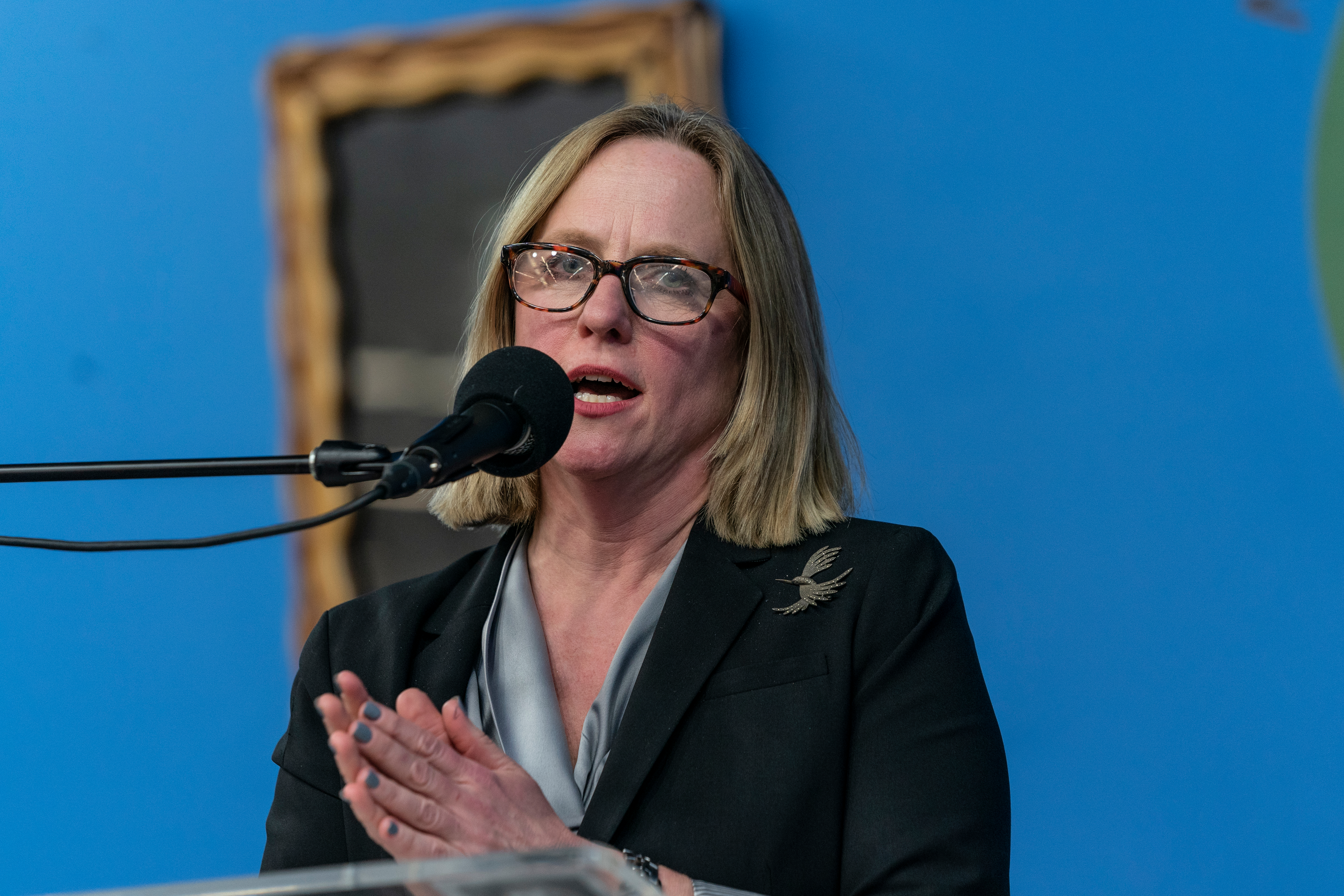 Melinda Katz wearing glasses at a lectern