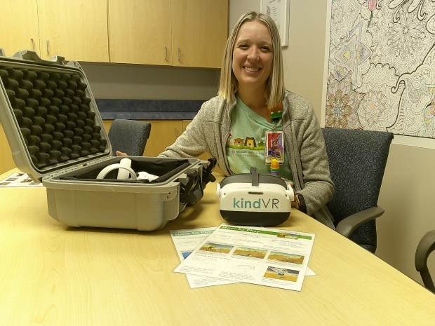 Annie Myren, a certified child life specialist at Advocate Children's Hospital in Oak Lawn, unpacks a virtual reality system the hospital makes available to young patients. (Susan DeGrane/Daily Southtown)