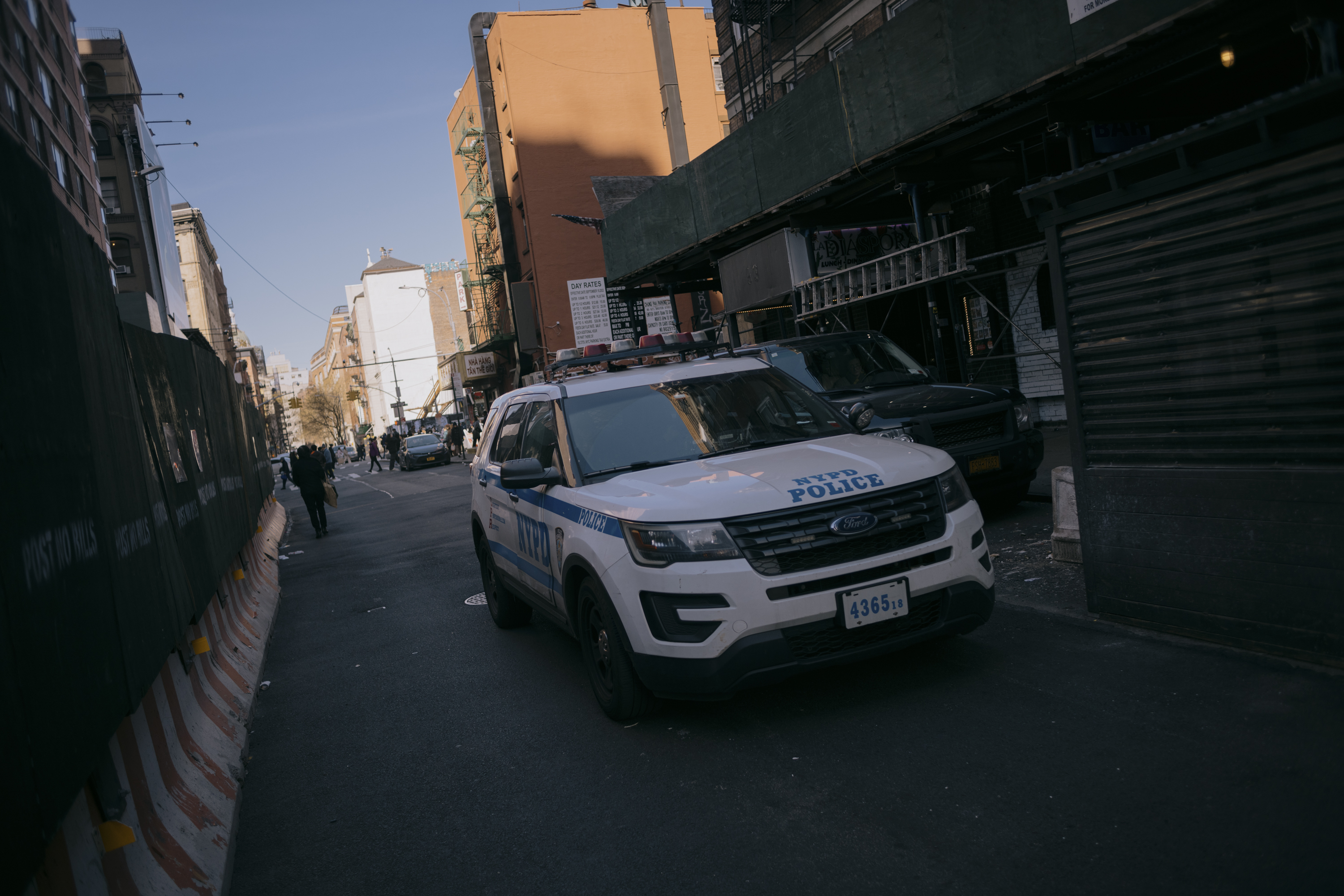 An NYPD vehicle drives down a street in Manhattan's Chinatown on March 8, 2024.