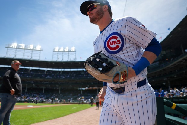 Chicago Cubs outfielder Ian Happ (8) runs onto the field before the game against the Milwaukee Brewers at Wrigley Field on May 5, 2024. (Eileen T. Meslar/Chicago Tribune)