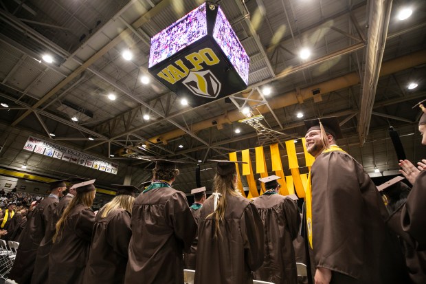 Carter Woody, right, stands up as he and the rest of Valparaiso University's class of 2024 leave the commencement ceremony, on Saturday, May 11, 2024, in Valparaiso. (Vincent D. Johnson/for the Post-Tribune)