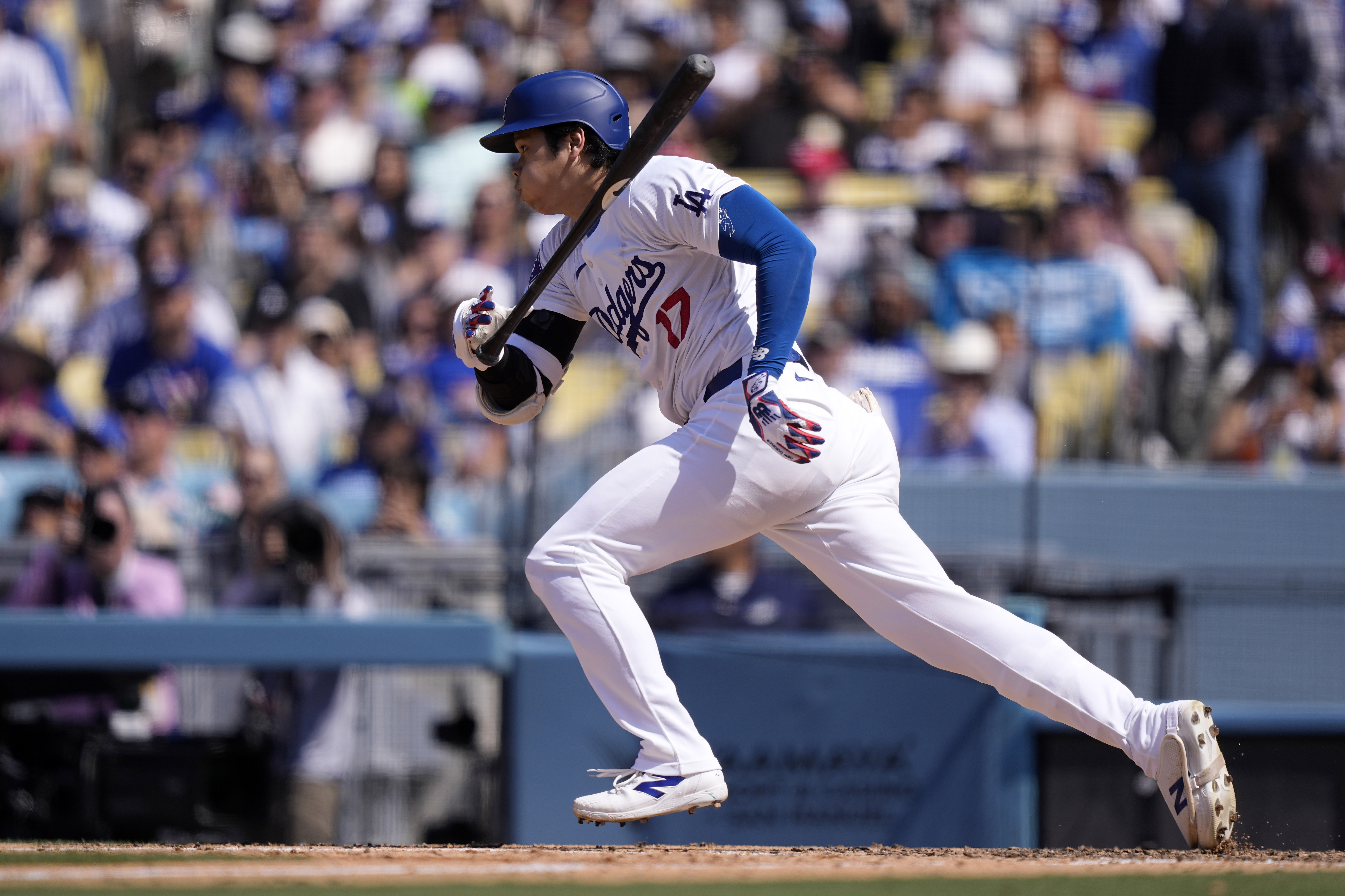 Los Angeles Dodgers’ Shohei Ohtani heads to first for a...