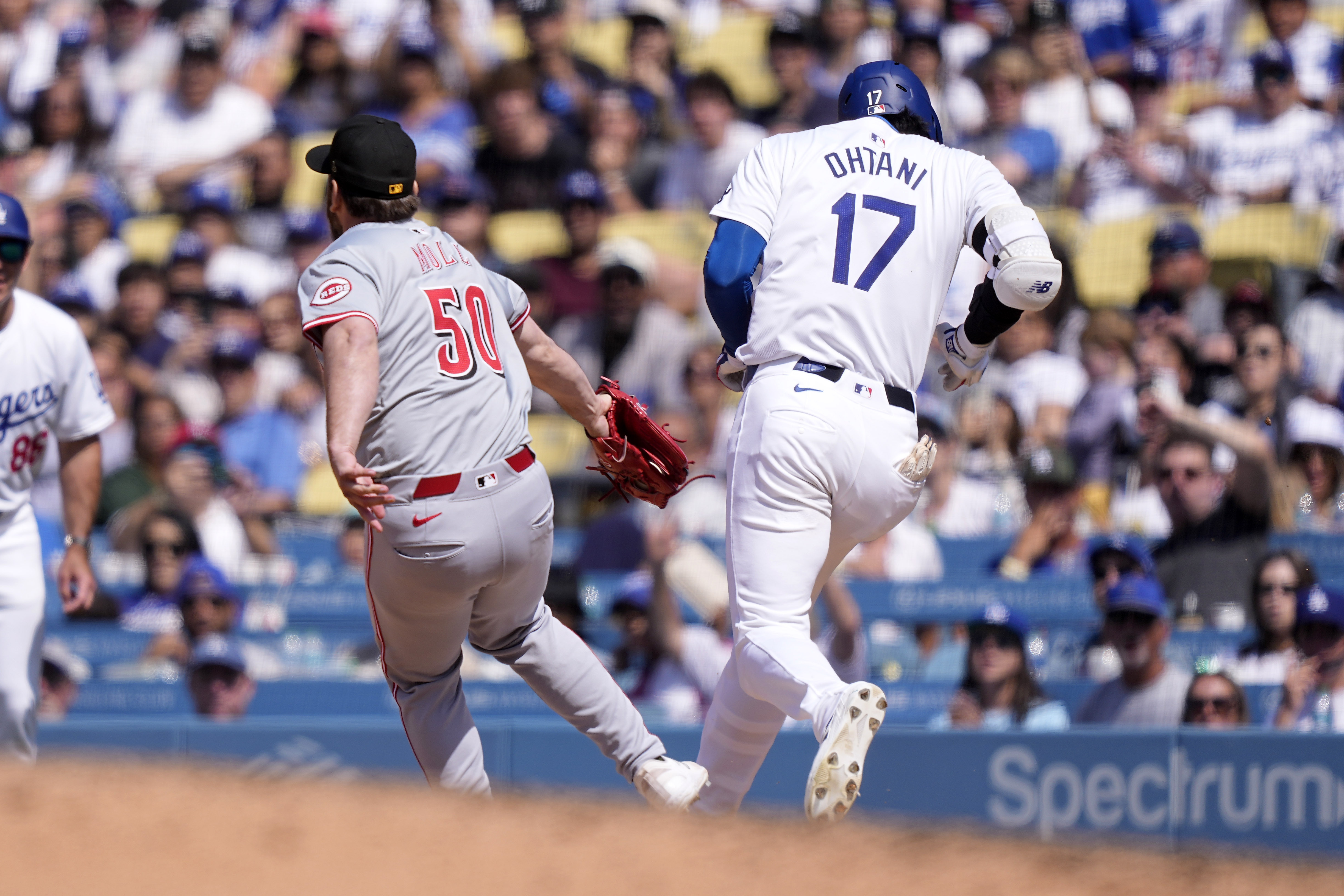 Los Angeles Dodgers’ Shohei Ohtani, right, is safe at first...