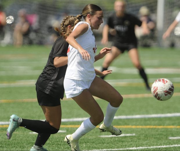 Metea Valley's Emma Strcic (4) and Naperville Central's Rebecca Ruggiero (32) chase down the loose ball during the Class 3A Naperville Central Regional championship game Saturday, May 18, 2024 in Naperville, IL. (Steve Johnston/Naperville Sun)