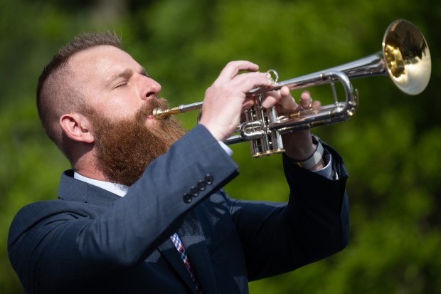 Deputy Porter County prosecutor Chris Hammer performs taps on the trumpet during Valparaiso's Memorial Day event on Friday, May 24, 2024. (Kyle Telechan/for the Post-Tribune)