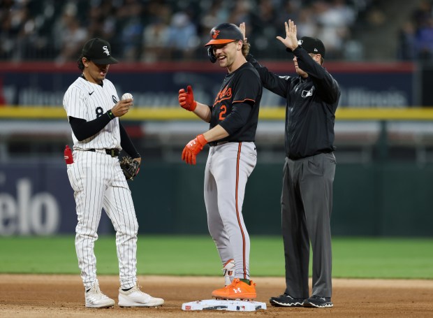 Orioles shortstop Gunnar Henderson (2) smiles after beating the throw to White Sox second baseman Nicky Lopez (8) for an RBI double in the third inning at Guaranteed Rate Field on May 24, 2024, in Chicago. (John J. Kim/Chicago Tribune)