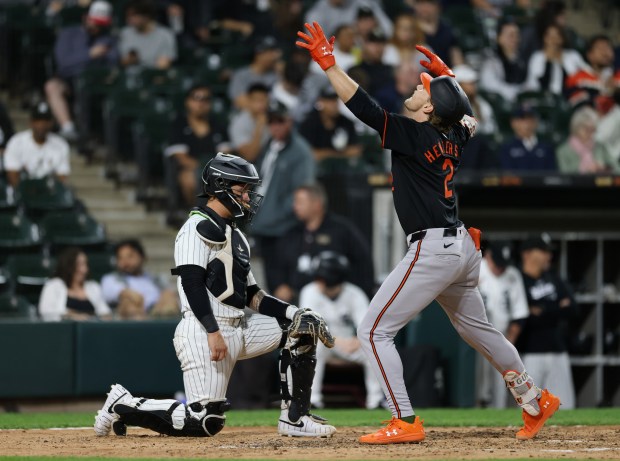 White Sox catcher Korey Lee (26), left, waits for Orioles shortstop Gunnar Henderson (2) to finish celebrating after Henderson hit a two-run home run in the fifth inning at Guaranteed Rate Field on May 24, 2024, in Chicago. (John J. Kim/Chicago Tribune)