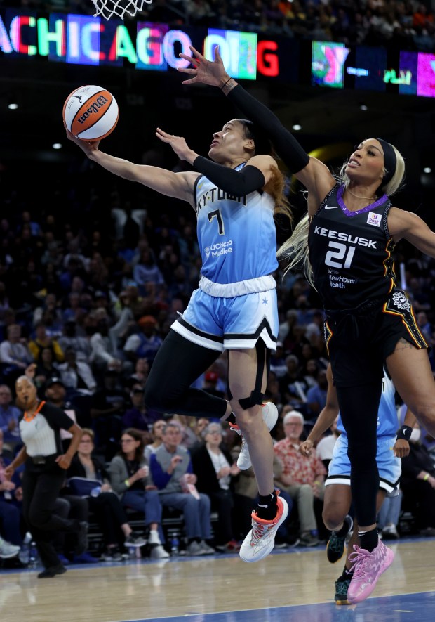 Chicago Sky guard Chennedy Carter (7) drives to the hoop on Connecticut Sun guard DiJonai Carrington (21) during the first half of the Sky's home opener at Wintrust Arena in Chicago on May 25, 2024. (Chris Sweda/Chicago Tribune)