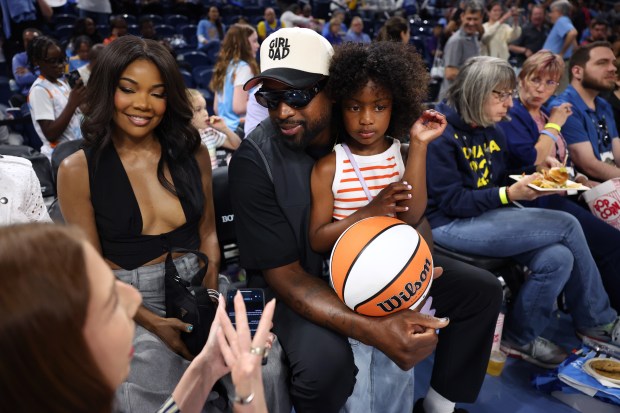 Dwyane Wade and Gabrielle Union sit courtside before the Sky's home opener against the Connecticut Sun at Wintrust Arena in Chicago on May 25, 2024. (Chris Sweda/Chicago Tribune)