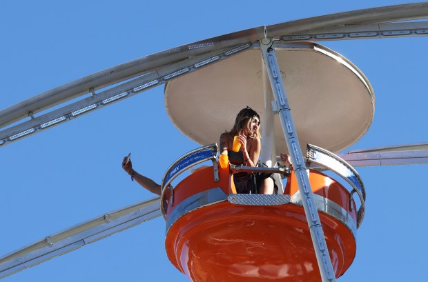 A concertgoer stands up in a Ferris wheel capsule during the Sueños Music Festival at Grant Park on May 25, 2024, in Chicago. (John J. Kim/Chicago Tribune)