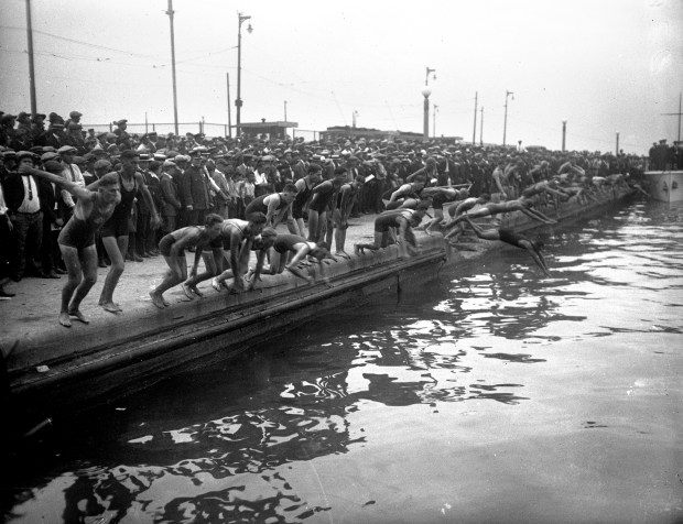 Swimmers compete at the start of the Chicago River race, circa 1920s. The race started on the north side of Municipal Pier, now called Navy Pier, and ended near the Jackson Blvd. Bridge. (Chicago Tribune historical photo)