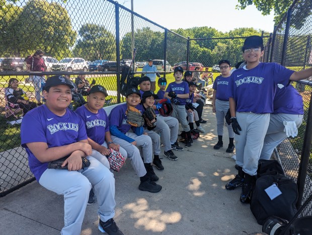 Members of the Rockies team smile for dugout photos during Saturday's Opening Day for Aurora Neighborhood Baseball League (MVP Photos)