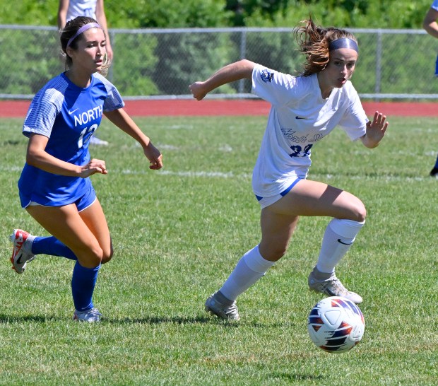 St. Charles North's Megan Hines, right, stays ahead of Wheaton North's Grace Kuczaj during the IHSA Class 3A South Elgin Sectional Girls Soccer Final at South Elgin High School in South Elgin, Saturday, May 25, 2024.(Michael Schmidt/For The Aurora Beacon-News)