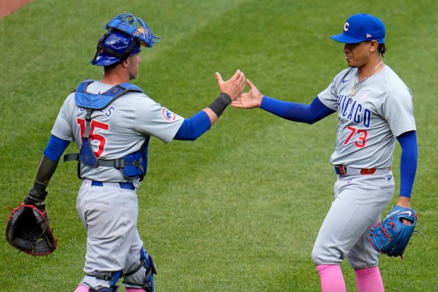 Cubs reliever Adbert Alzolay celebrates with catcher Yan Gomes after getting the final out in the 10th inning to preserve a win over the Pirates on Sunday, May 12, 2024, in Pittsburgh. (AP Photo/Gene J. Puskar)