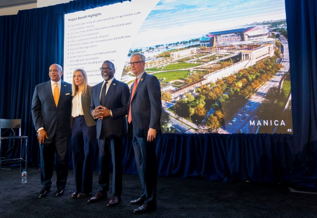 Team President and CEO Kevin Warren, Karen Murphy, executive vice president of stadium development, Mayor Brandon Johnson, and chairman George McCaskey in front of a rendering after the Bears announced plans to build a new domed lakefront stadium on April 24, 2024, at Soldier Field. (Brian Cassella/Chicago Tribune)