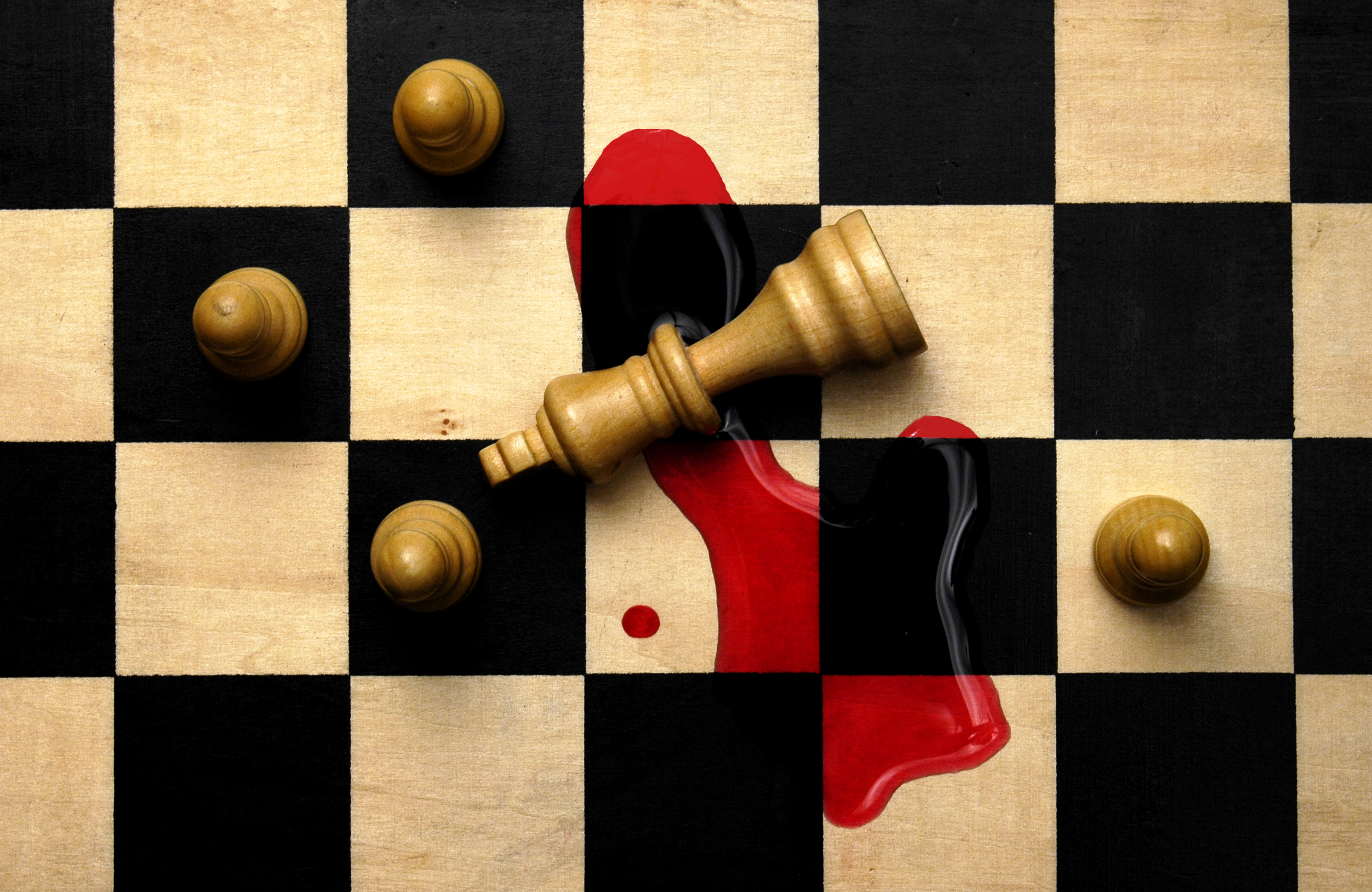 a chess piece with blood on the board