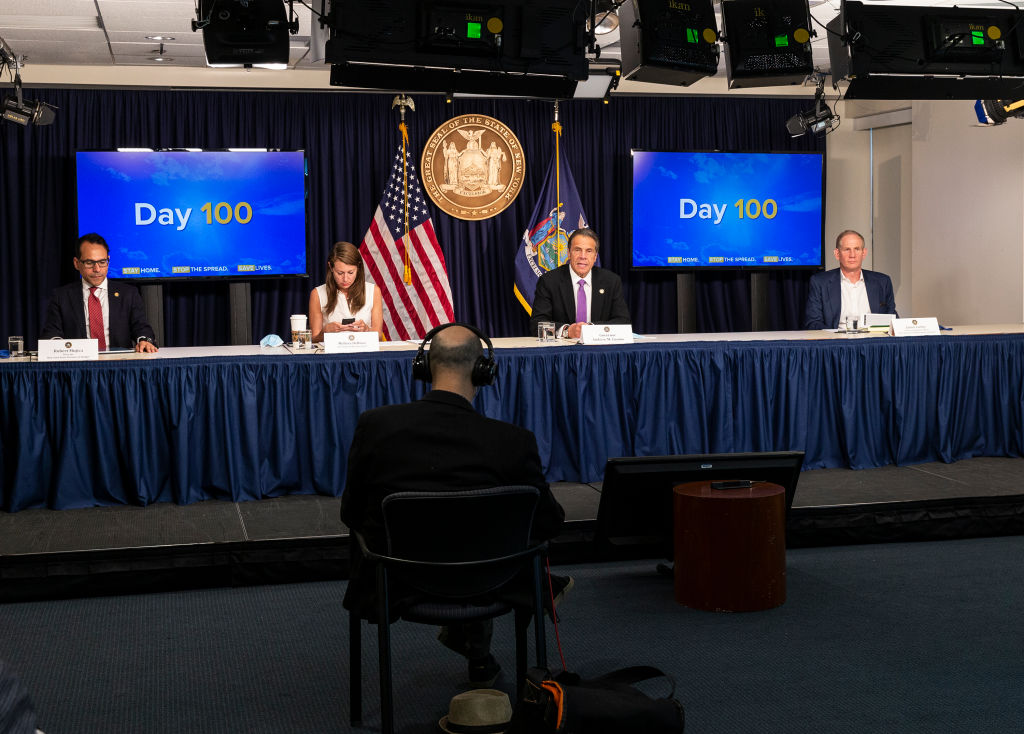 Former Gov. Andre Cuomo and members of his cabinet sit behind a table during a June 2020 COVID-19 briefing.