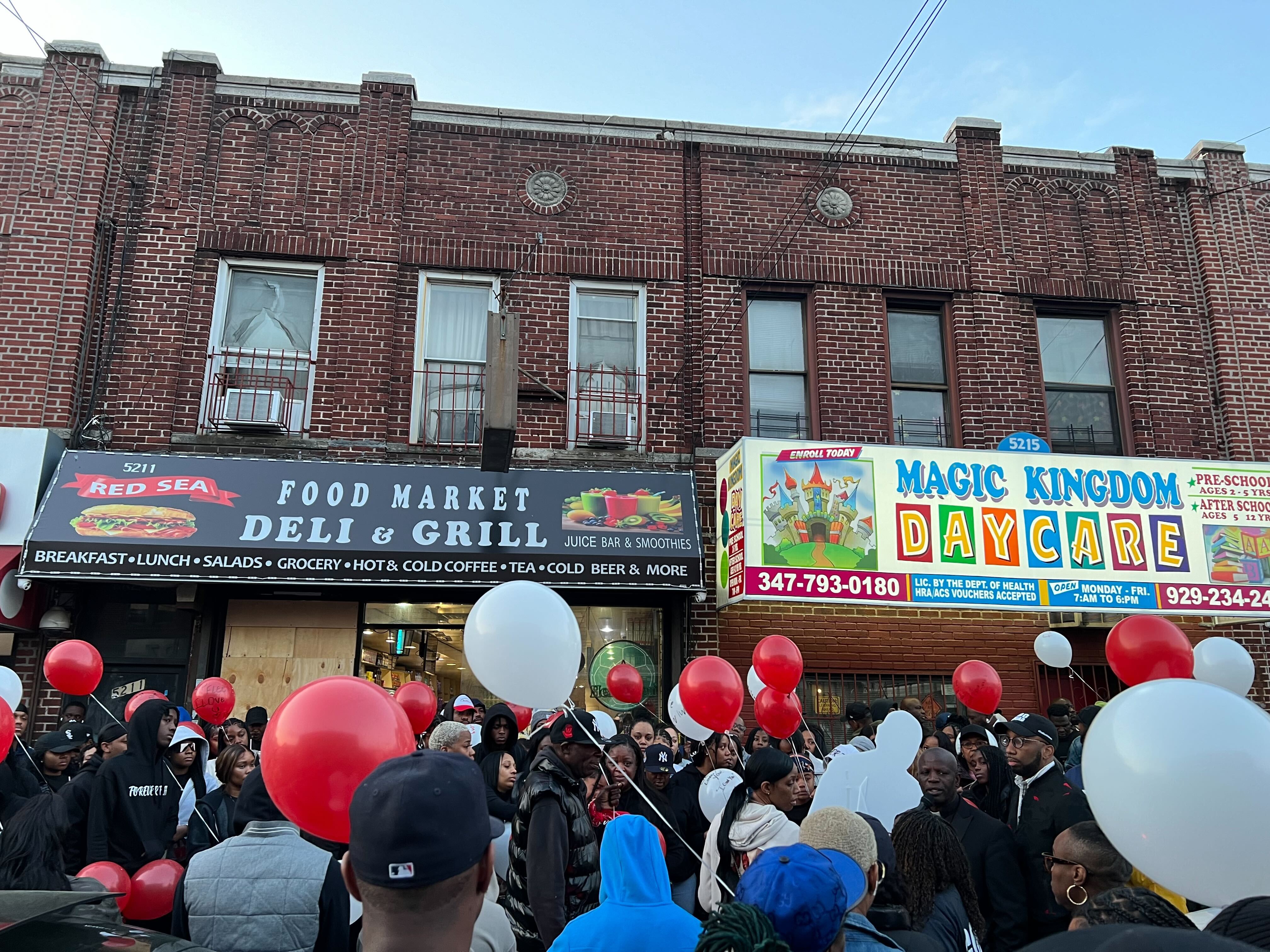 Emile’s family and friends prepare to release balloons inscribed with personal messages Monday night.