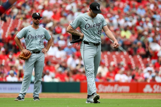 Chicago White Sox starting pitcher Garrett Crochet, right, stretches his calf after being hit by a ball off the bat of St. Louis Cardinals' Lars Nootbaar during the third inning of a baseball game Sunday, May 5, 2024, in St. Louis. (AP Photo/Scott Kane)