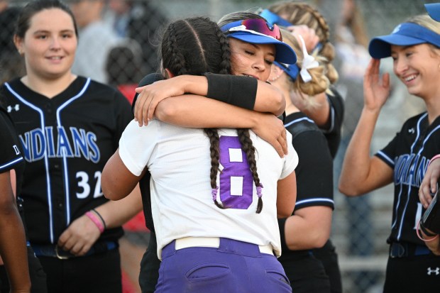 Lake Central's MaKayla Van Vossen hugs Hobart's Keirys Click after her team's win over Hobart in the Class 4A regional on Thursday, May 30, 2024. (Kyle Telechan/for the Post-Tribune)